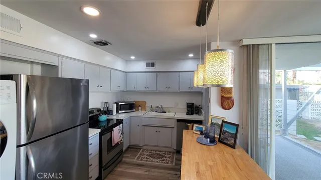 a kitchen with a refrigerator a sink and a cabinets