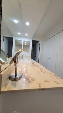 a spacious bathroom with a double vanity sink toilet and shower