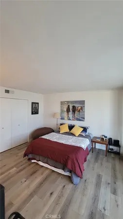 a bedroom with a bed a window and a mirror