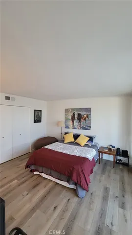 a bedroom with a bed a window and a mirror