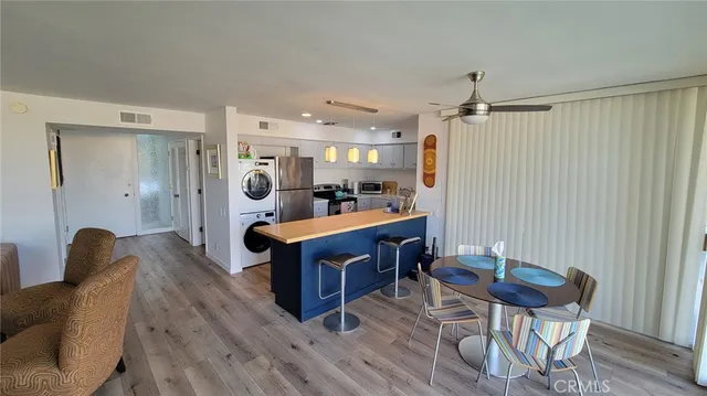 a living room with furniture a dining table and wooden floor