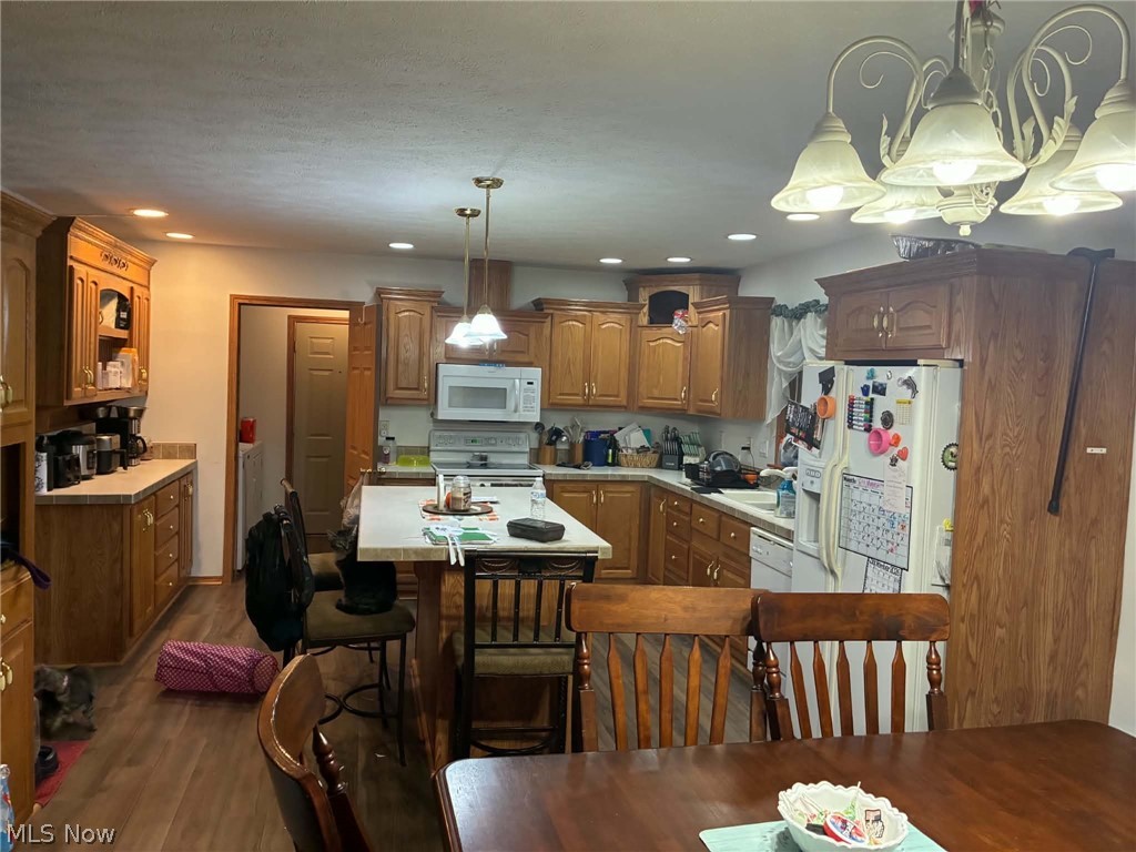 4601 Bessemer Road Nelsonville, OH 45764 - Photo 3 of 25 Kitchen featuring wood-finish cabinetry, recessed lighting, and a center island with seating