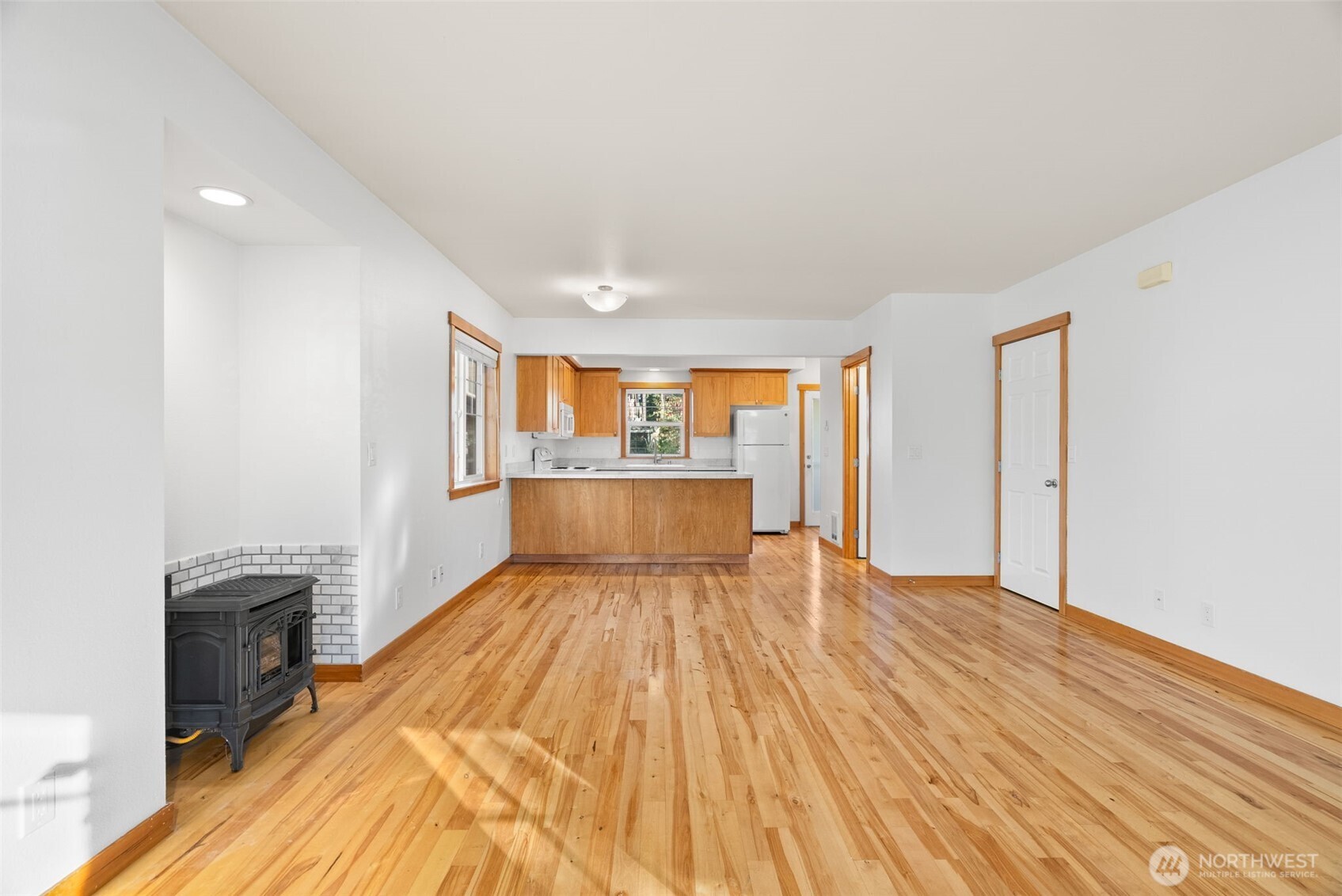 1322 Polly's Lane Bainbridge Island, WA 98110 - Photo 11 of 29 a view of a kitchen with wooden floor a sink and staircase