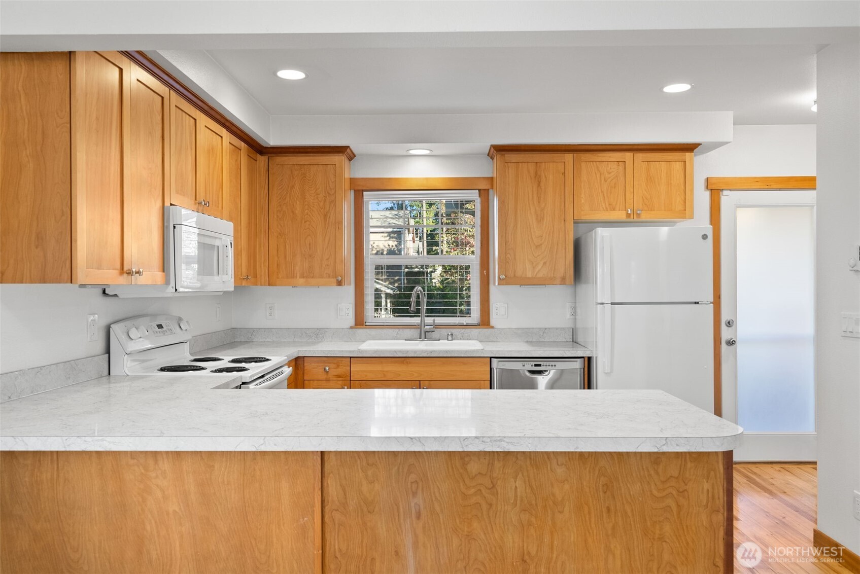 1322 Polly's Lane Bainbridge Island, WA 98110 - Photo 12 of 29 a kitchen with a sink a refrigerator and a window