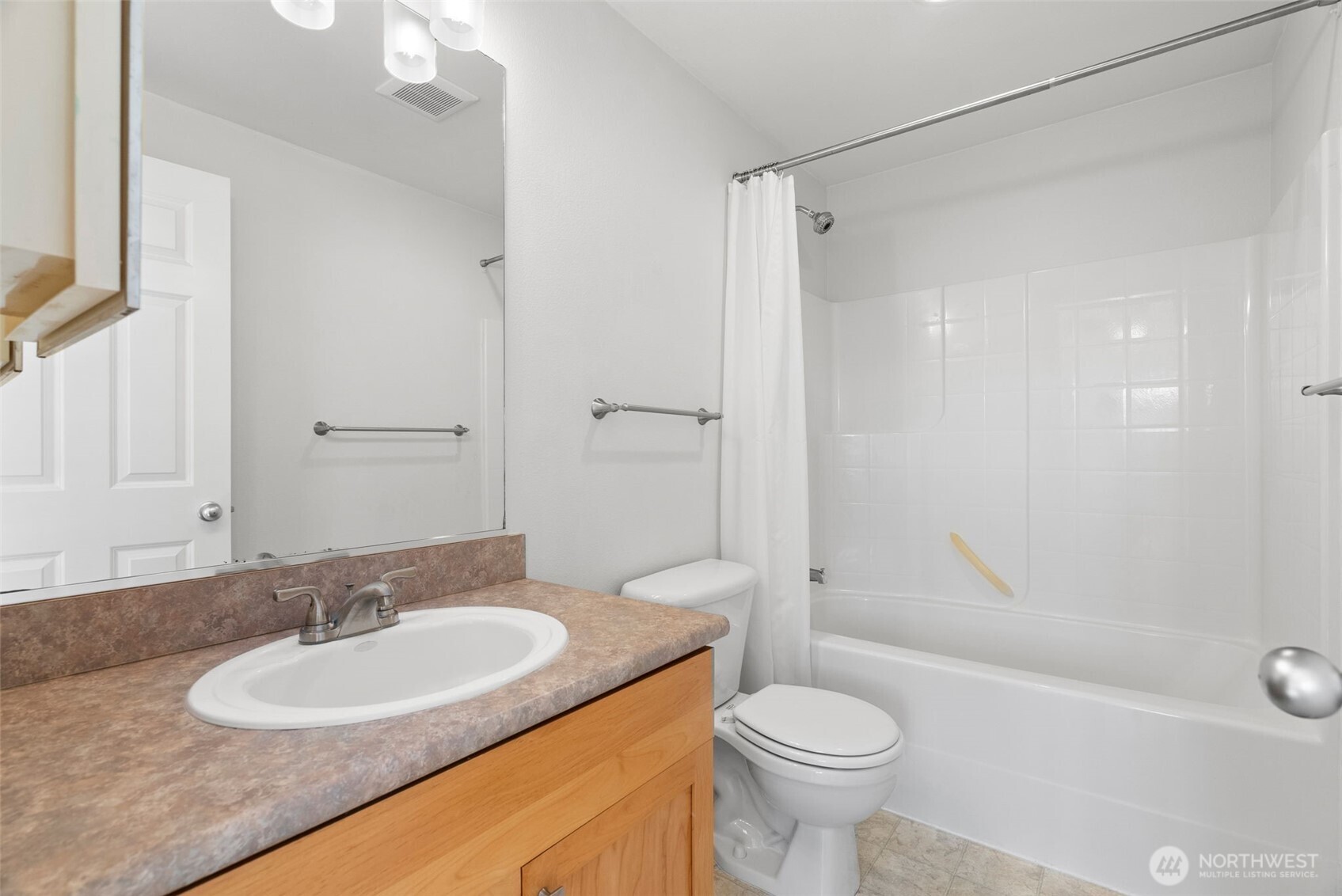 1322 Polly's Lane Bainbridge Island, WA 98110 - Photo 19 of 29 a bathroom with a granite countertop sink toilet and shower