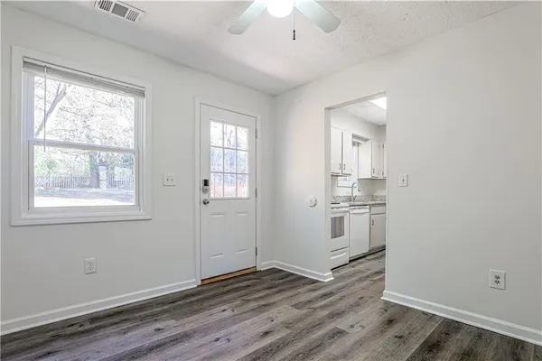 a kitchen with a sink cabinets stainless steel appliances and a window