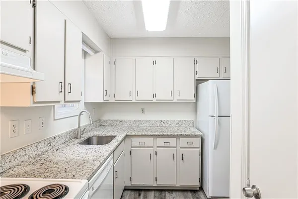 a kitchen with a sink and a stove top oven