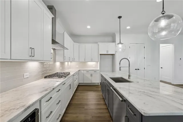 a large kitchen with granite countertop a stove and a sink