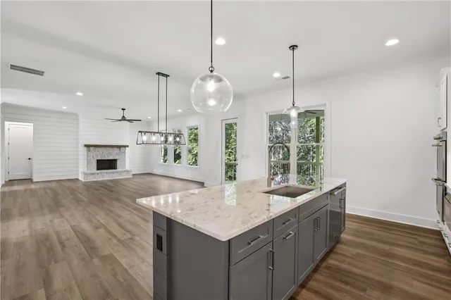 a kitchen with stainless steel appliances granite countertop a stove a refrigerator and a stove