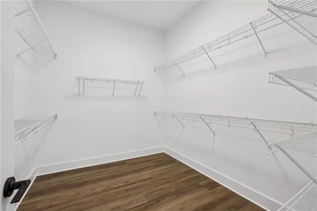 a view of a hallway with wooden floor and entryway