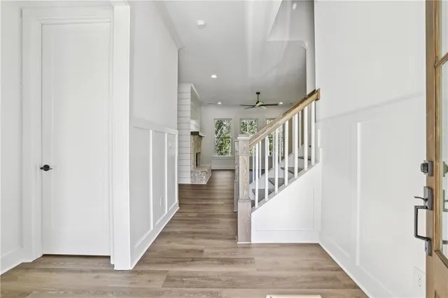 a view of a hallway with wooden floor and staircase