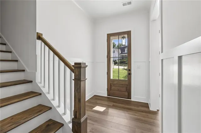 an empty room with windows and ceiling fan