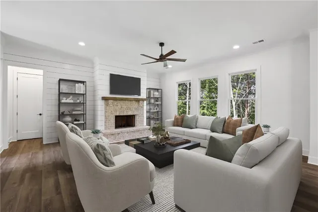 a living room with furniture a fireplace and a flat screen tv