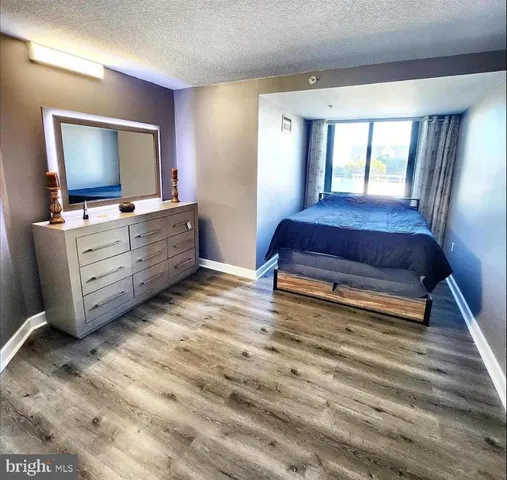 a living room with furniture a flat screen tv and dresser