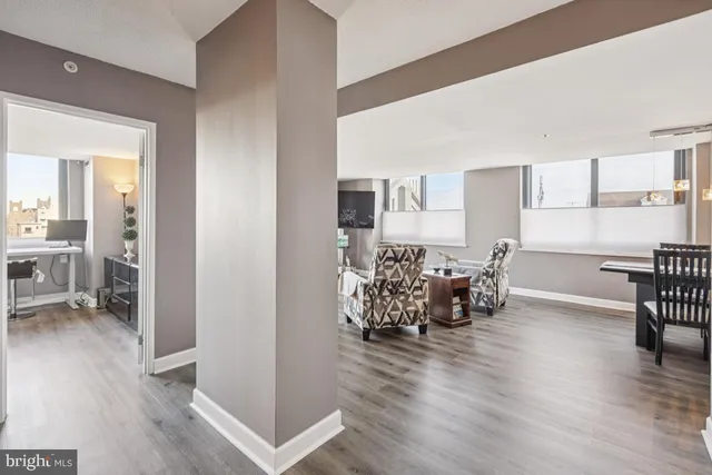 a dining room with furniture and wooden floor
