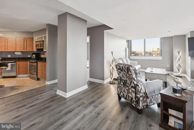 a living room with furniture and a wooden floor