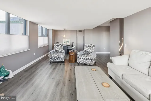 a living room with furniture and large windows