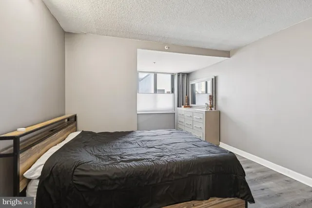 a bedroom with a bed and cabinets