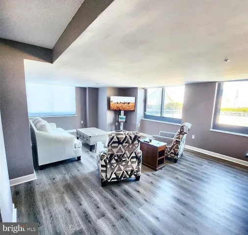 a bedroom with furniture window and wooden floor