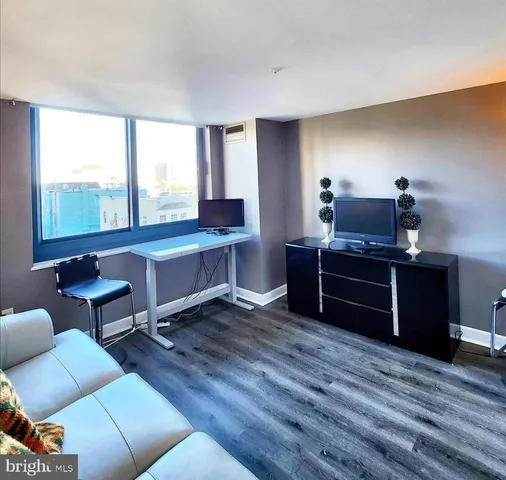 a view of a workspace with furniture and a window