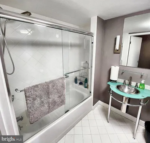 a bathroom with a tub and a view of bathroom