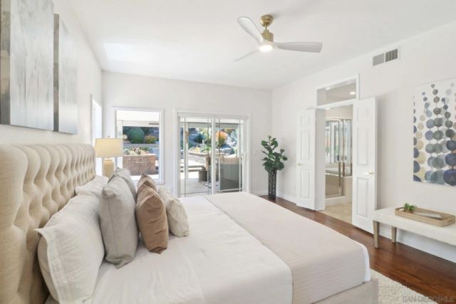 a bedroom with a large bed and a chandelier