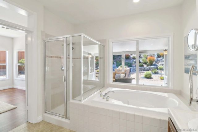 a bathroom with a bathtub a shower a sink and a shower