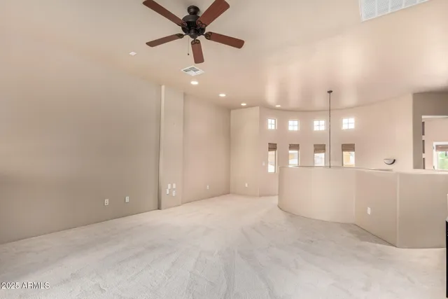 a view of an empty room and kitchen view