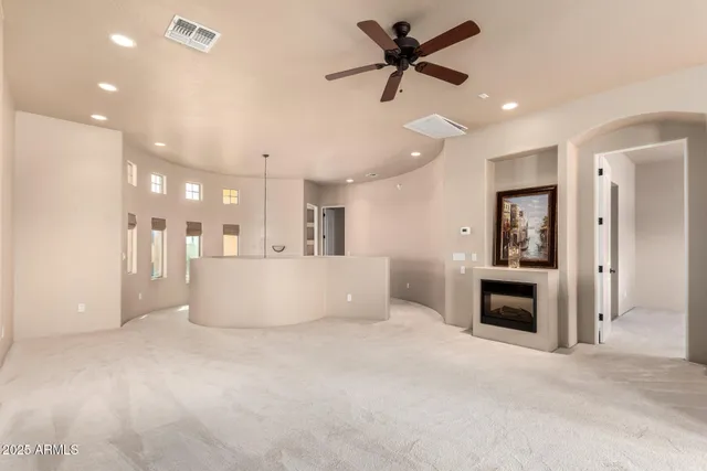 a view of a living room and a ceiling fan