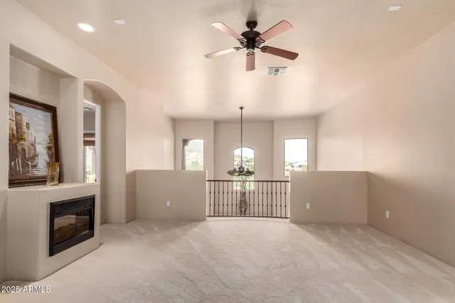 a view of a livingroom with furniture fireplace and windows