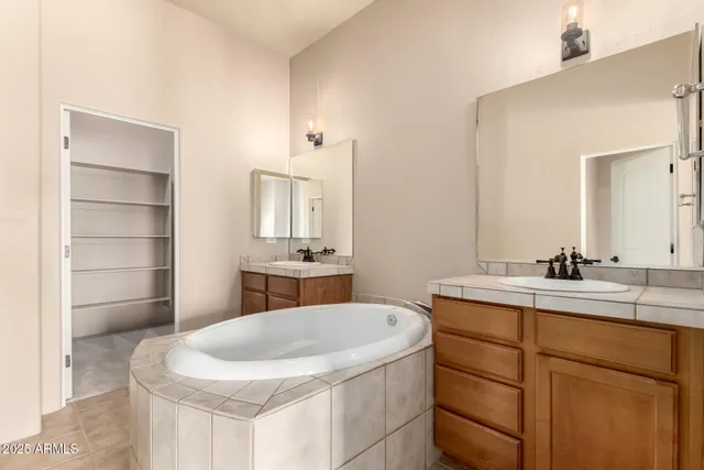 a bathroom with a sink double vanity and a mirror
