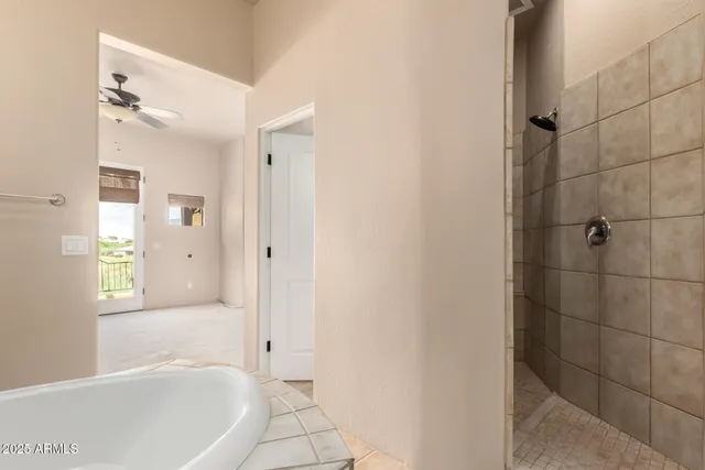 a spacious bathroom with a bathtub and a shower