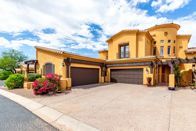 a view of a house with large trees and potted plants