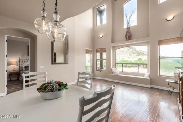 a dining room with wooden floor chandelier and livingroom