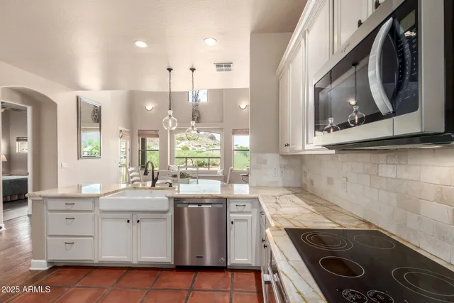 a kitchen with a sink stove and cabinets