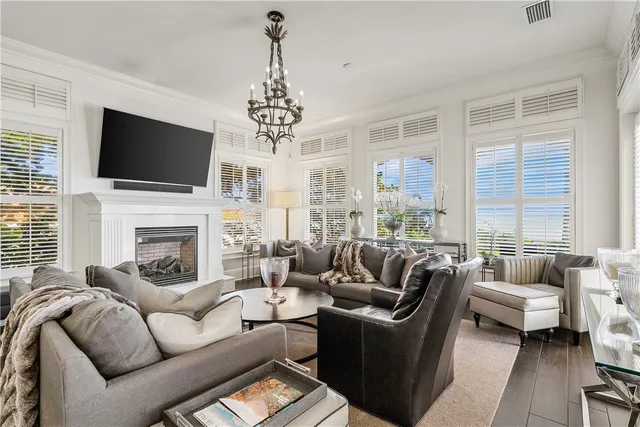 a living room with furniture fireplace and flat screen tv