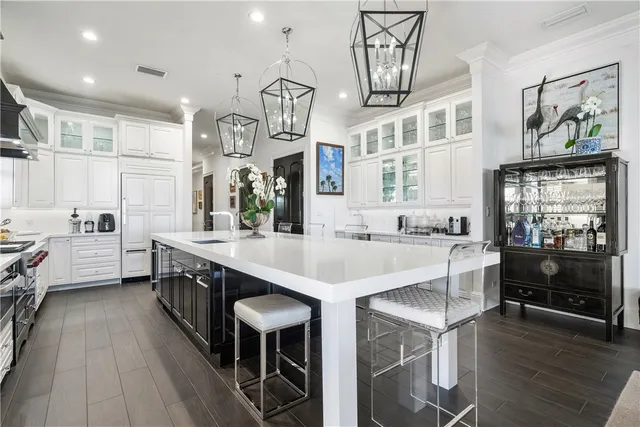 a large kitchen with a table and chairs in it