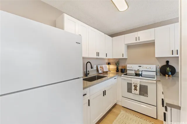 a kitchen with stainless steel appliances granite countertop white refrigerator a stove a sink and dishwasher