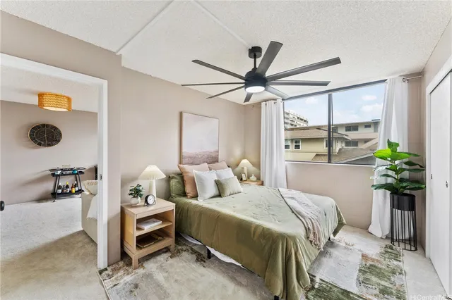 a bedroom with a balcony a bed and a chandelier