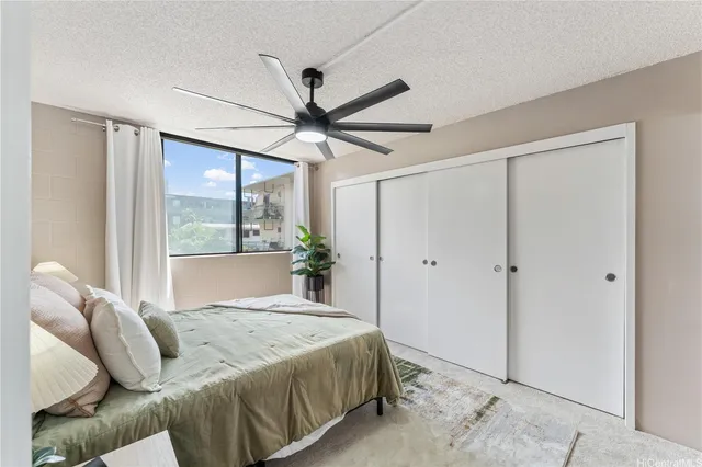 a bedroom with a large bed and a chandelier