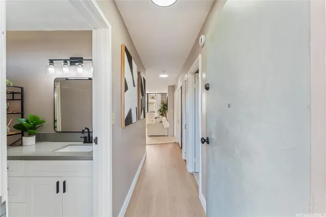 a view of a hallway with paintings on the wall