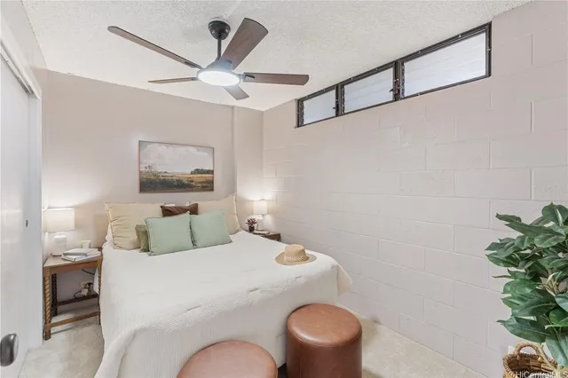 a bedroom with a bed and a potted plant