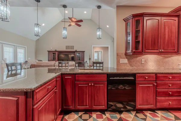 a kitchen with a sink cabinets and wooden floor