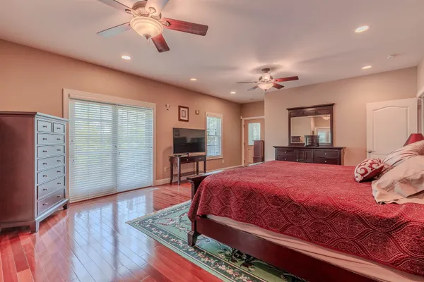 a bedroom with furniture and a flat screen tv