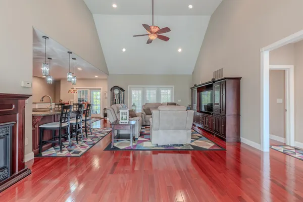a living room with furniture and wooden floor