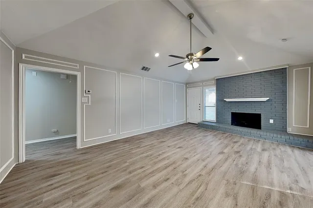 wooden floor in an empty room with a fireplace