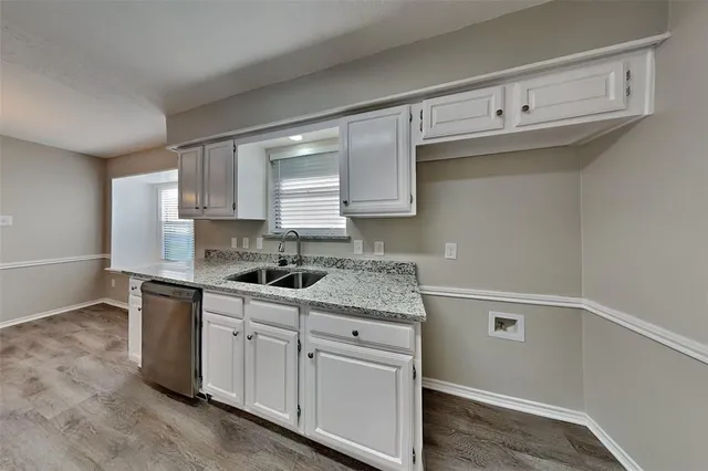 a kitchen with white cabinets and white appliances