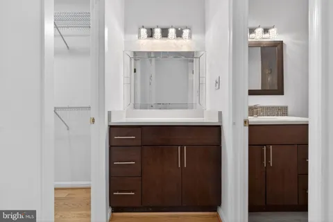 a bathroom with a sink vanity and mirror