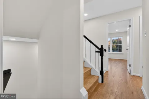 a view of entryway with wooden floor and stairs