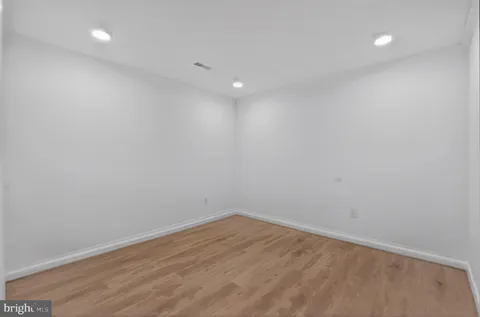 a view of room with wooden floor and fan